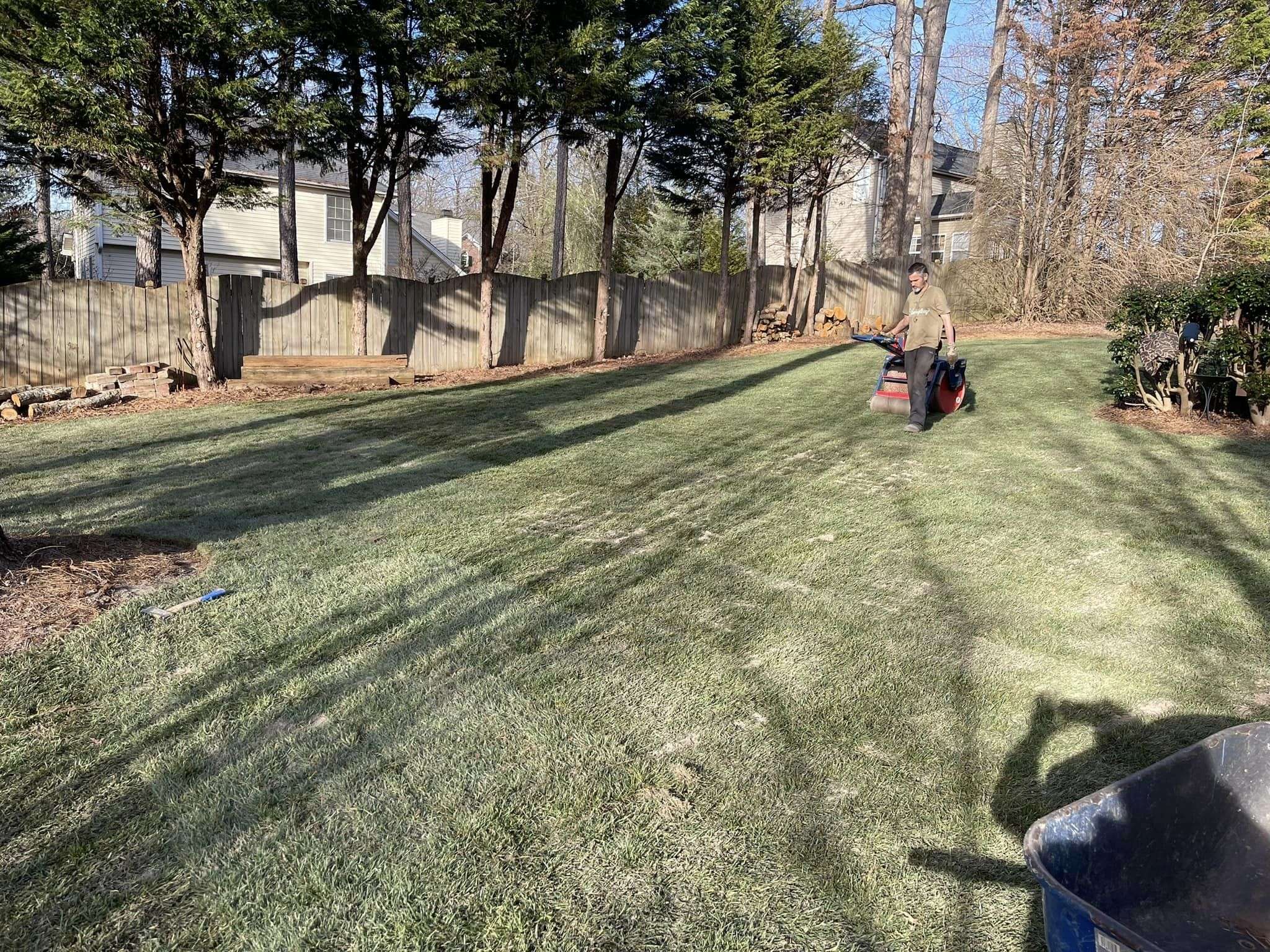 New Boiling Springs sod installation in a backyard, showcasing fresh green grass and a wooden fence