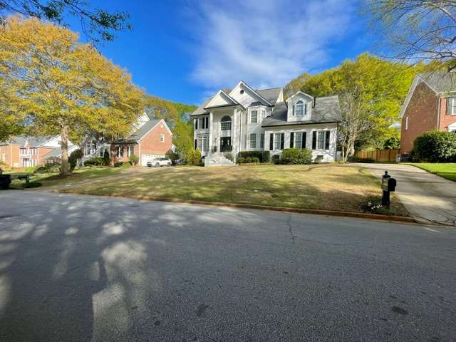 Residential lawn area with recently installed sod, showcasing a spacious home and surrounding landscape in Travelers Rest, SC, emphasizing the importance of professional sod installation for a healthy lawn.
